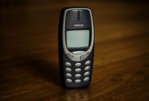 Retro cellphone with buttons placed on table